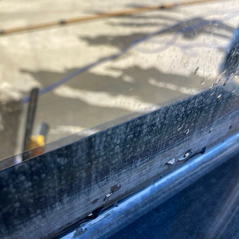 Hard water stain removal on office windows in Riverside, California by Ecoworks Window Cleaning.