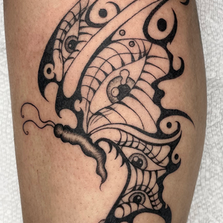 blackwork butterfly with tribal style wings and eyeballs in the wings