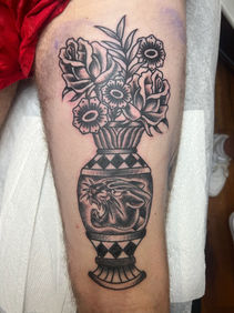 traditional style black and gray vase with flowers