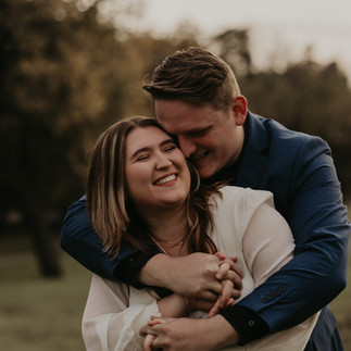 Lifestyle couples photography capturing a joyful, unposed embrace between partners, focused on authentic emotion, comfort, and connection in a soft natural light Dallas setting.