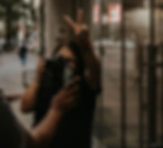 Dallas wedding photographer capturing a candid mirror reflection downtown while flashing a peace sign, documentary-style branding portrait by SHOTS BY LC