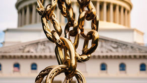 Gold chains hanging in front of the United States Capitol Building.