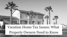 A black and white photograph of a large, two-story modern vacation home situated along a waterfront, framed by several tall palm trees under a clear sky. A prominent white text box overlays the lower-middle section of the image, reading "Vacation Home Tax Issues: What Property Owners Need to Know".
