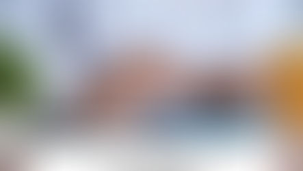 Hands on a blue calculator, person in a plaid shirt. A plant and yellow cup nearby. Text reads: What Happens When You Miss the Tax Deadline?