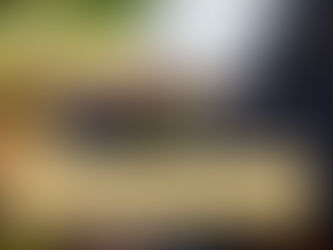 Two men in formal wear sit outdoors on a bench. One holds a tablet, gesturing as they have a discussion. Lush greenery in the background. With an overlay titled Estate and Insurance Planning for Business Owners