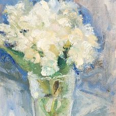 bunch of small white flowers in a glass