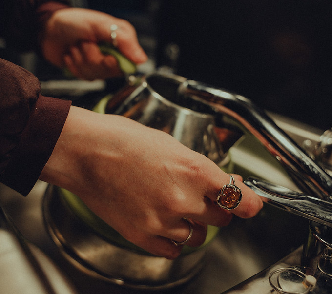 lady filling kettle in campervan