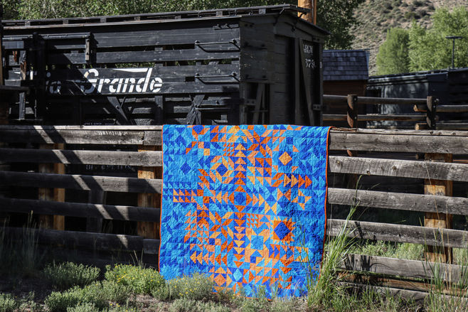 Driven Quilt by A Squared Studio in front of an old box car. Geometric, modern quilt design