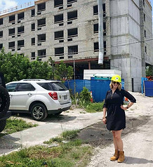 Photograph of women standing in front of a construction site