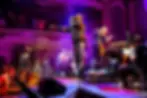 Rapper Trilla Jermaine Trillowski performing on stage with a live orchestra