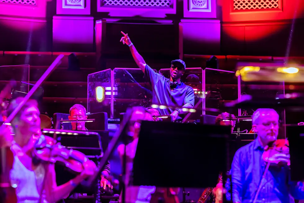 Conductor leading a bassline symphony and orchestra