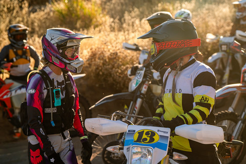 dirt bike riders talking to each other