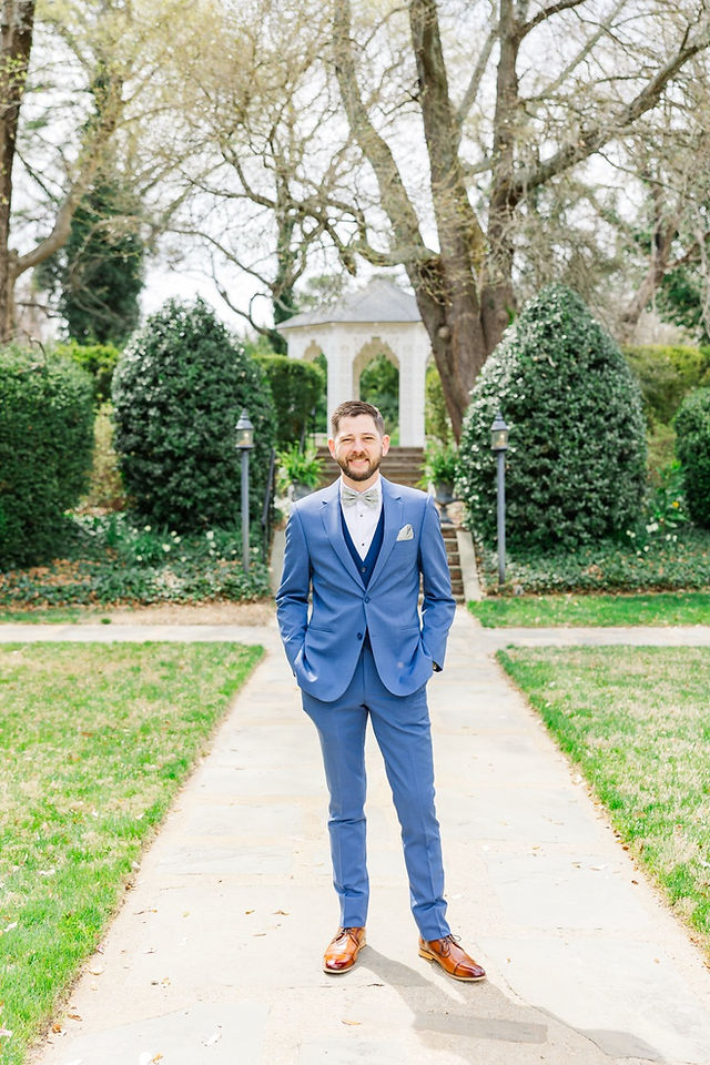 	5.	Groom standing outdoors in blue suit, waiting for first look