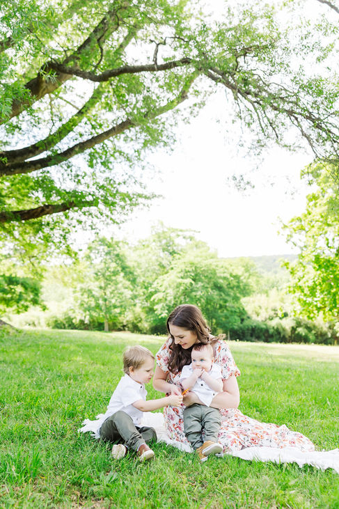 14. Mom and baby playing on grass under tree