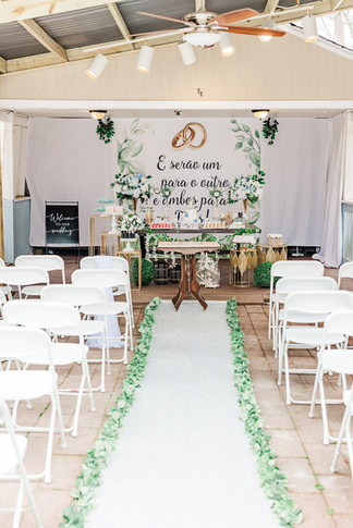 11. Ceremony setup with white chairs and greenery aisle at a Richmond VA backyard wedding