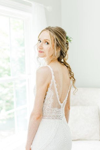 3. Bride smiling softly with natural makeup and loose updo