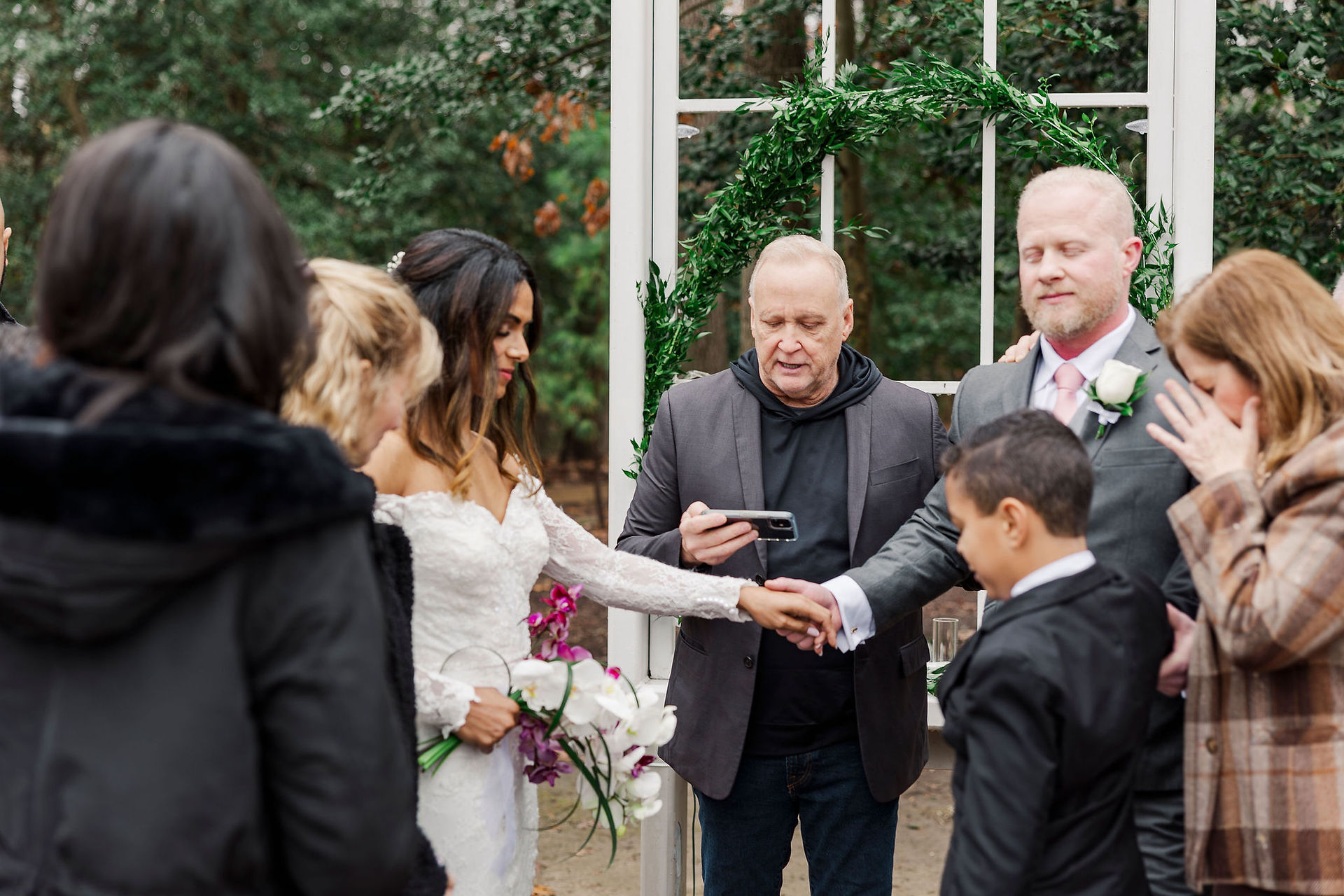 Officiant leading a heartfelt wedding ceremony as the bride and groom exchange vows at Polegreen Church in Richmond, VA.