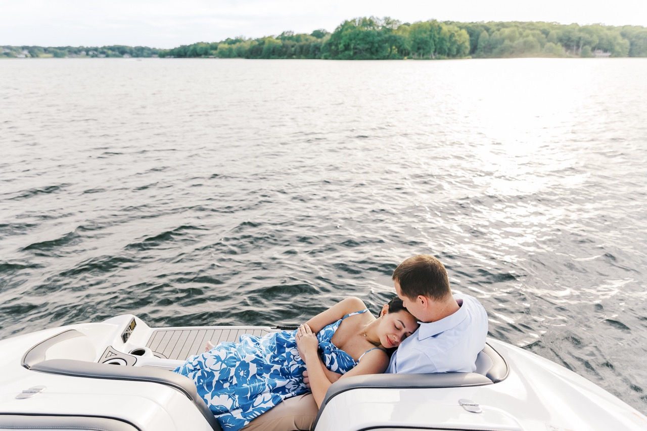 	12.	Man resting his head on his fiancée’s lap while lying on the boat, soaking in the moment.