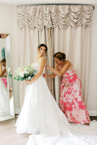 33. Bride holding bouquet while getting ready for Virginia wedding