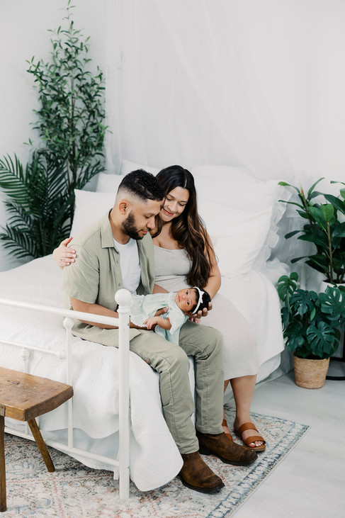 	9.	Parents sitting together holding newborn daughter during Richmond studio session