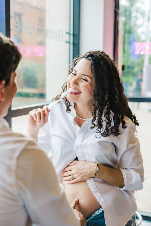 13. Husband laughing with wife during playful maternity photo session at Chaps Ice Cream