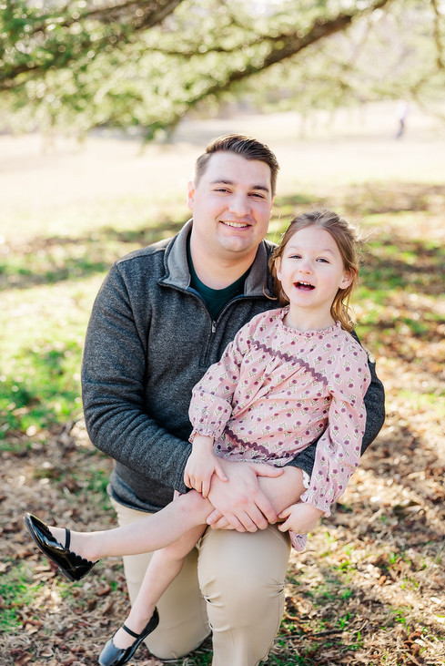 11. family of four sitting together on grass at Maymont Park in Richmond Virginia