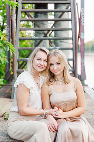 “A sweet mother-daughter moment as they sit together by the canal, framed by greenery and historic structures at Great Shiplock Park in Richmond, VA.”