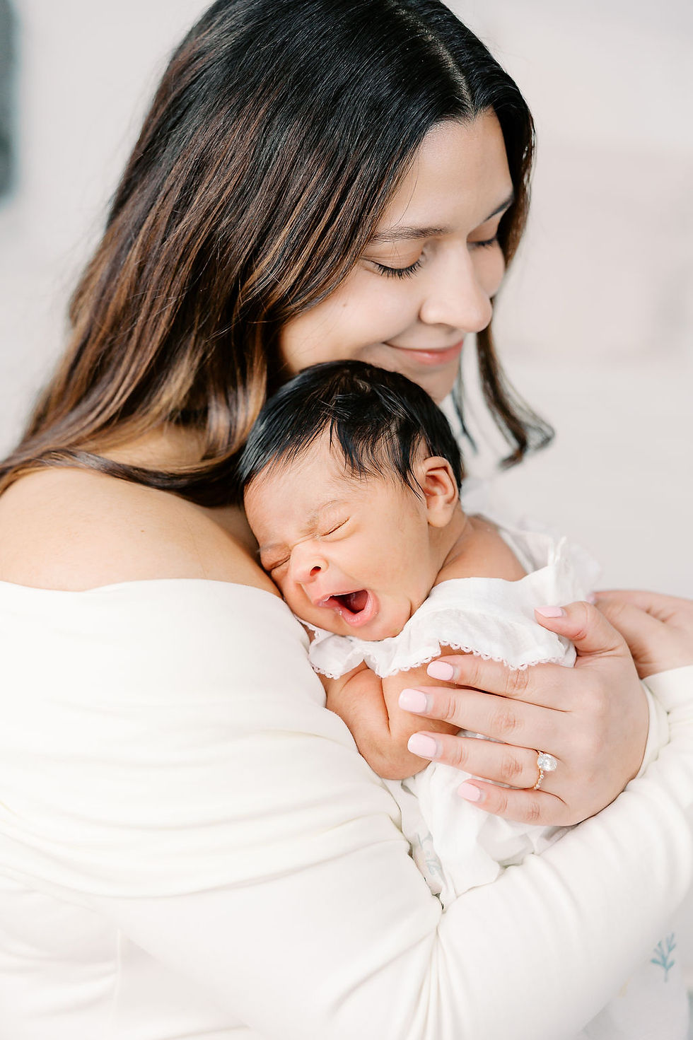 Mother holding newborn baby girl during studio newborn session in Richmond Virginia