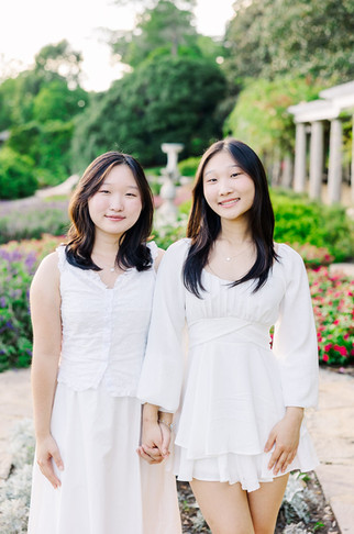Parents laughing with their daughters during a relaxed family photoshoot at Maymont gardens.