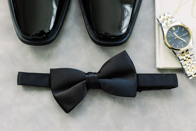 4. Flat lay of groom’s accessories with bow tie and cufflinks — elegant wedding morning details captured at The Dominion Club.