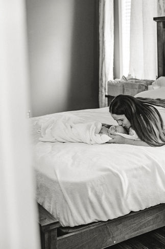 5. Richmond photographer photographing quiet moment of newborn sleeping on bed.