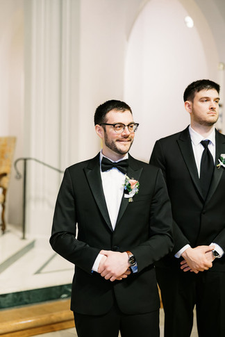 11. Groom watching the wedding processional at St. Bridget Catholic Church in Richmond VA
