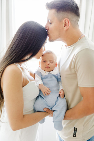 	11.	Parents cuddling newborn baby in nursery filled with natural light