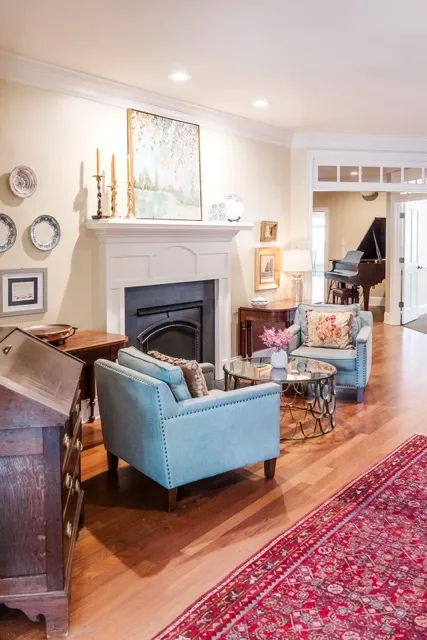 	6.	Elegant lounge area inside The Mill at Fine Creek, featuring a cozy fireplace, blue armchairs, and classic decor.