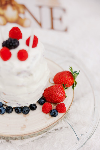 Baby boy with birthday cake during outdoor cake smash session in Richmond VA
