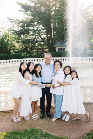 Close-up of the Lee family sharing laughs and hugs near the fountain at Maymont in Richmond, VA.