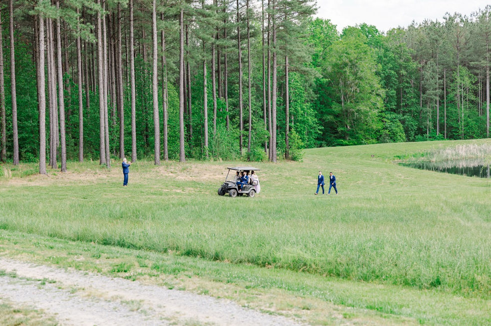 2. Wedding party walking across field at Timber Creek Farm