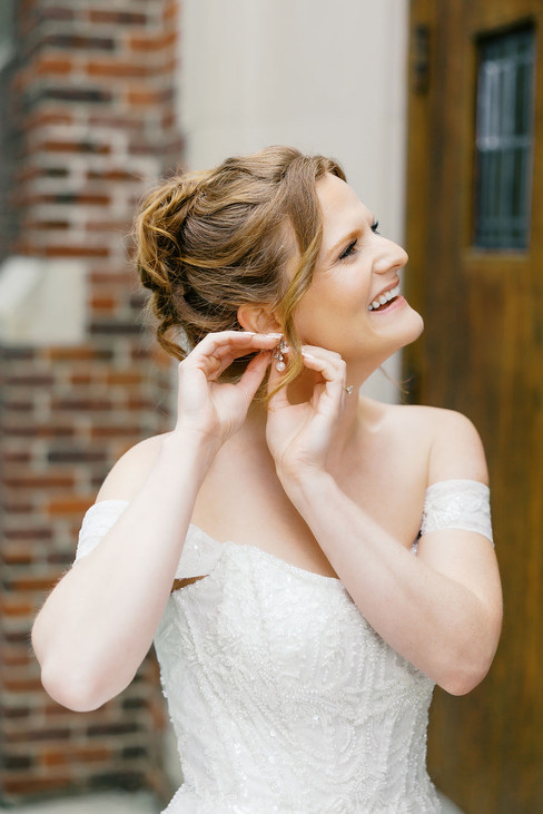 27. Bride putting on earrings before her classic spring wedding in Richmond Virginia