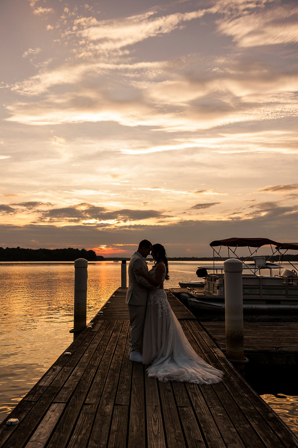 	1.	Bride sitting gracefully on the dock at sunset, overlooking Swift Creek Reservoir at The Boathouse.
