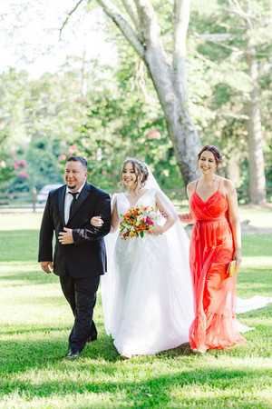 	10.	“Bride walking down the aisle with parents during summer wedding at The Virginia Cliffe Inn”