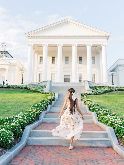 Senior walking up the steps of the Virginia Capitol in Richmond, VA, during her senior portrait session.