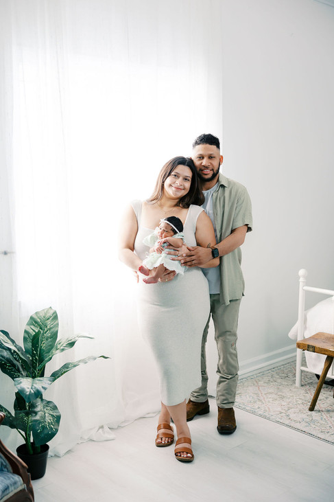 	1.	Parents holding newborn baby girl during studio newborn session in Richmond Virginia