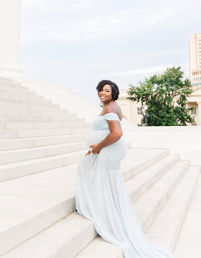 Pregnant woman walking up the stairs of the Virginia Capitol during a maternity session in Richmond, VA.