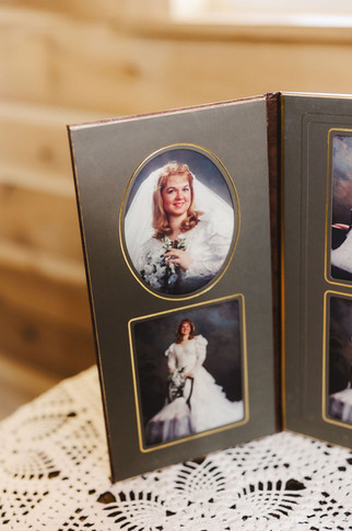 	10.	Vintage-style photo display of bride’s family members in wedding gowns