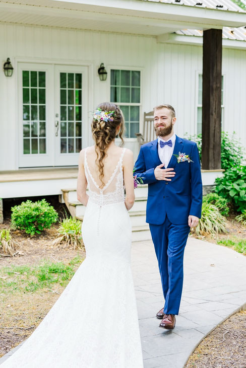 6. Groom smiling during first look at outdoor wedding