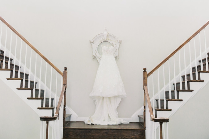 26. Wedding dress hanging on staircase at Antebellum of New Kent