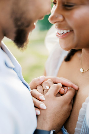 33. Close-up of Sallie holding Anthony’s hand during their engagement session