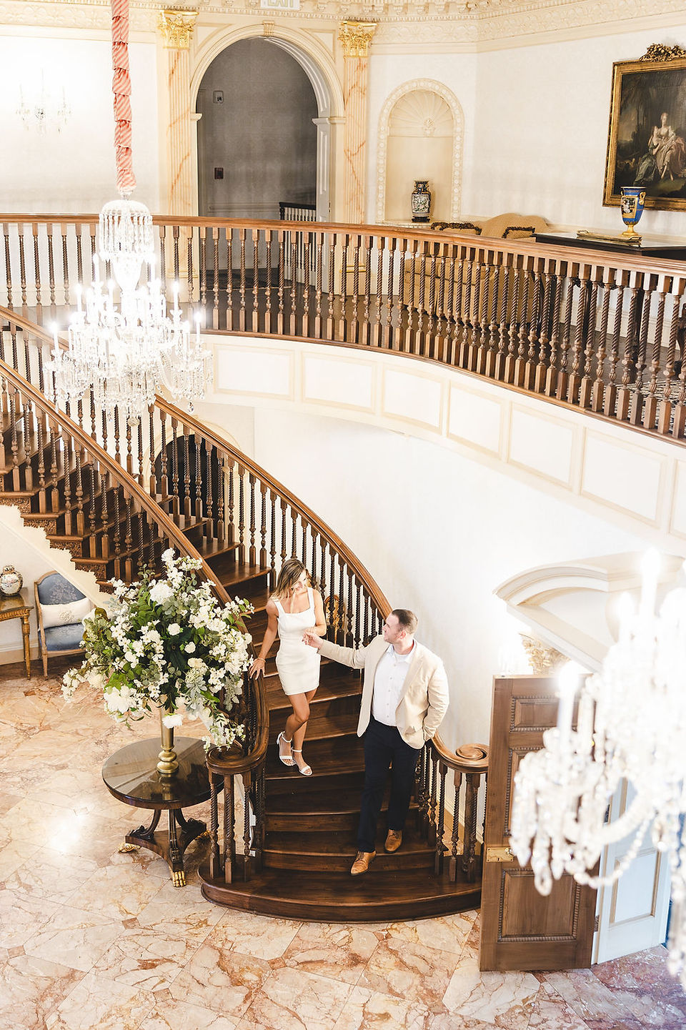 	7.	Bride and groom-to-be standing on the iconic grand staircase of the Estate at River Run.