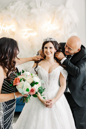 6. Parents fastening necklace around bride’s neck — loving wedding morning captured in Richmond, VA.