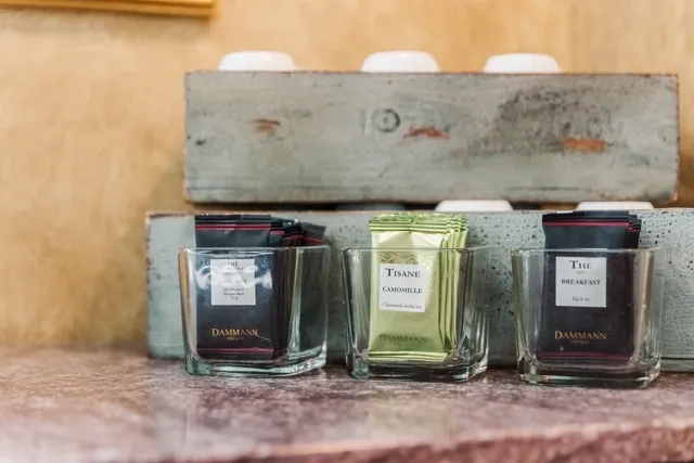 	11.	Set of elegant glass candle holders with different scents, arranged on a rustic wooden tray.